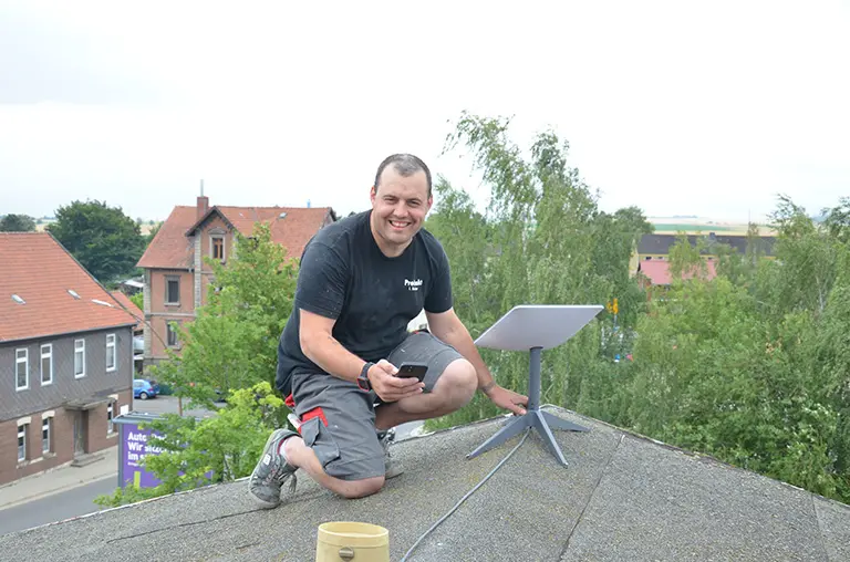 Techniker Ivo Baltzer bei der Montage der Starlink-Antenne.